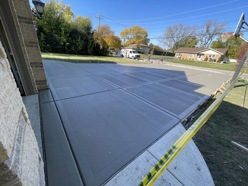 Newly poured concrete driveway with score-line patterns