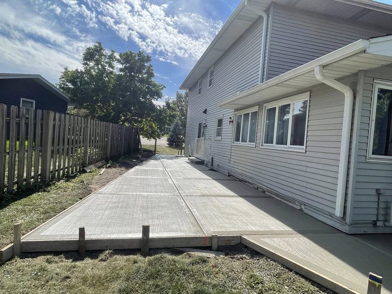 Side-yard concrete patio with broom finish