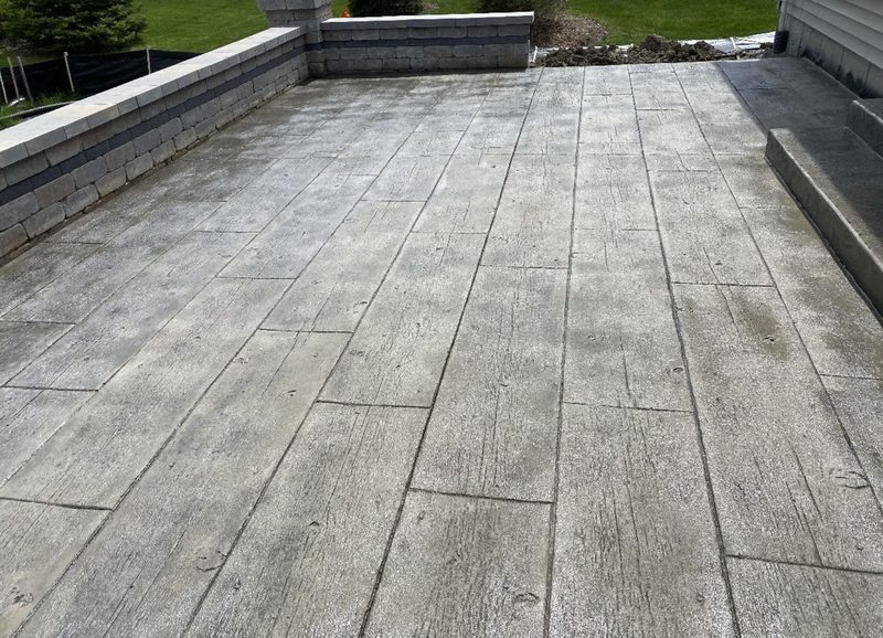 Stamped concrete patio with weathered wood-plank pattern