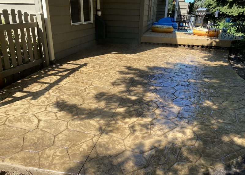 Stamped concrete patio with tan cobblestone pattern