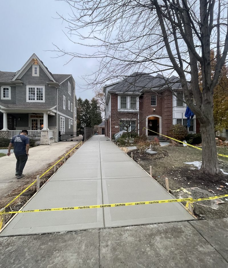 Concrete driveway between two houses