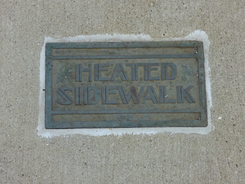Metal Heated Sidewalk plate set into a concrete walk
